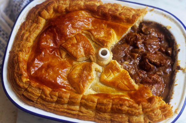 a meat pie in a blue and white dish