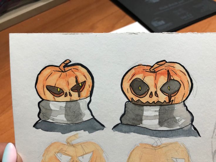 a drawing of two pumpkins with faces on them