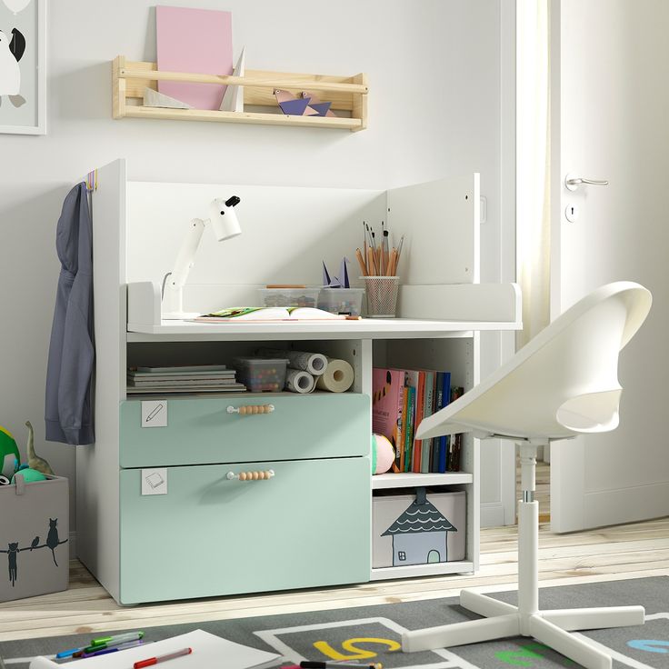 a child's room with a desk, chair and bookshelf in it