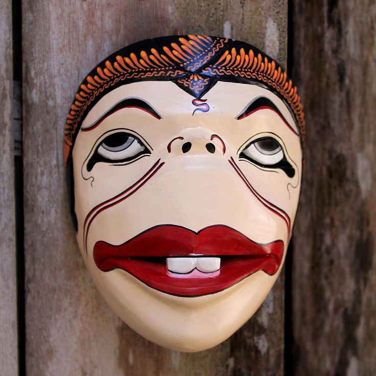 One of the four punokawan or clowns from Javanese shadow puppetry Semar is the leader or father figure of the other three. Traditionally such characters would provide comic relief but also social criticism. Tri Sugiyanti works to preserve Javanese cultural heritage by recreating Semar in this unique mask. The mask is craved from albesia wood and carefully painted by hand. Shadow Puppetry, Unique Masks, Wood Mask, Comic Relief, Buy Wood, Father Figure, Premium Gift, The Leader, Artisan Craft