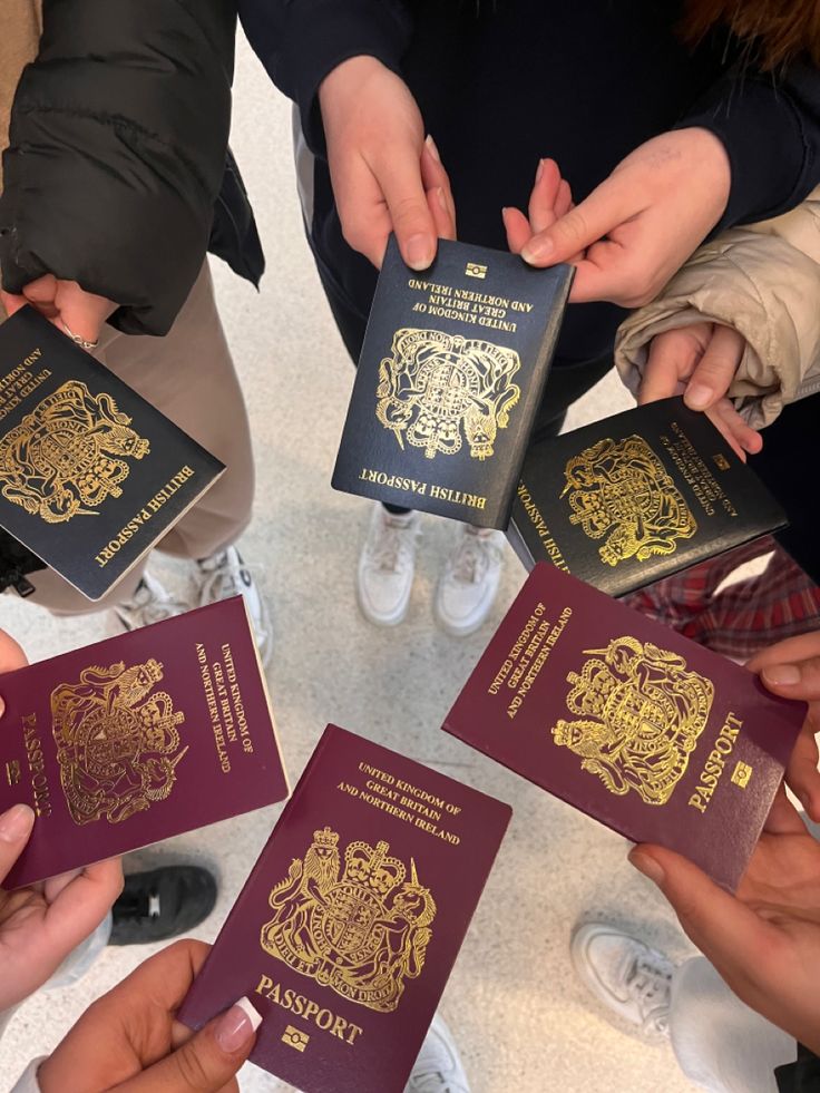 several people holding their passports in the middle of a circle