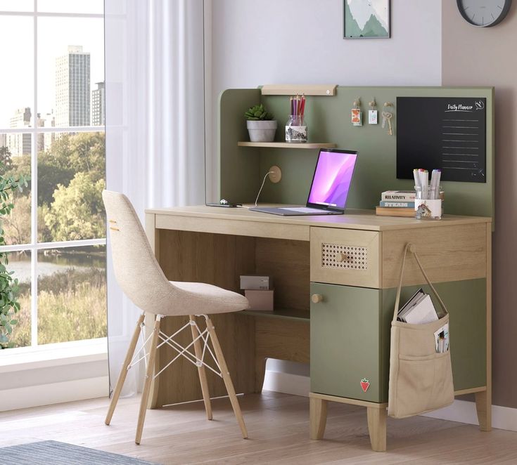 a desk with a laptop on it in front of a window and a chair next to it