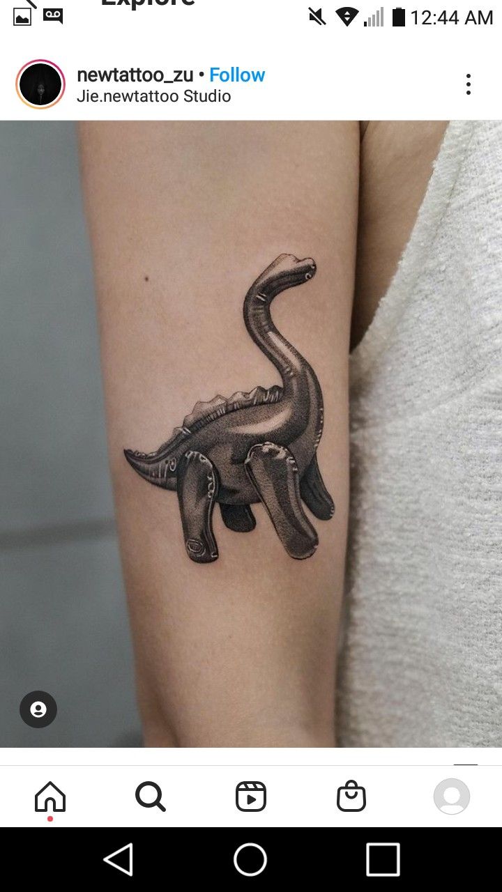 a small tattoo on the arm of a woman with an elephant in black and white