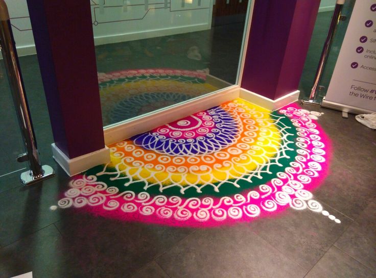 a brightly colored rug on the floor in front of a mirror with an open door