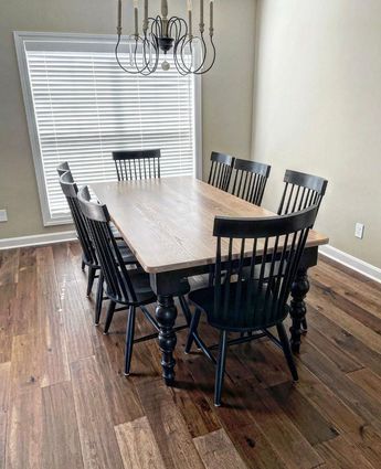 a dining room table with chairs and a chandelier