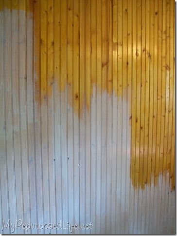 the wall is painted yellow and white with wood slats