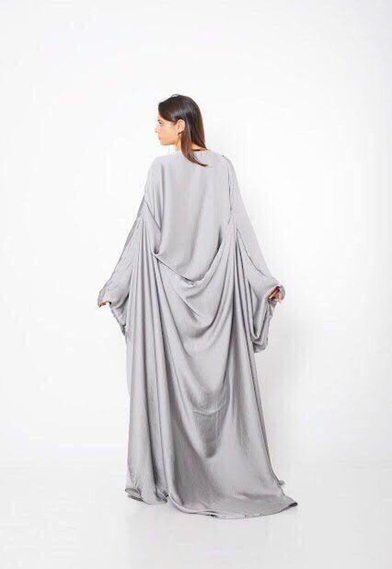 "Abaya Dress, Plus Size Maxi Dress, Silk Dress ♛ All of Rosche's pieces are created with the sole purpose that YOU feel beautiful! Enjoy unique details in combination with high-quality materials every day and make an statement every place you go! ♛ Perfect for every occasion! ♛ Custom fit: Your comfort in essential to us, so we can make the garment specially with your measurements. ♛ Material & Care: Silver silk ABAYA, chiffon Dry clean ♛ Delivery: Ready to ship in 3-5 business days. STANDAR Flowy Maxi-length Abaya For Eid, Flowy Long Abaya For Eid, Long Gown For Eid, Maxi Length Khimar For Wedding, Long Khimar For Wedding, Flowy Maxi Dress For Eid, Flowy Eid Maxi Dress, Silk Maxi Length Abaya, Bohemian Maxi Abaya For Wedding