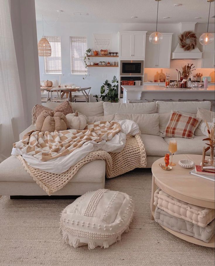 a living room filled with lots of furniture and pillows on top of it's couches