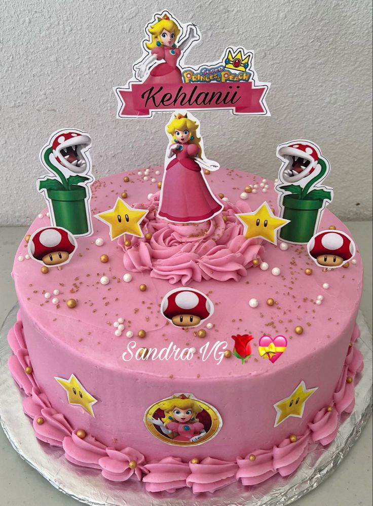 a pink birthday cake with mario and princess peaches on the top, surrounded by stars