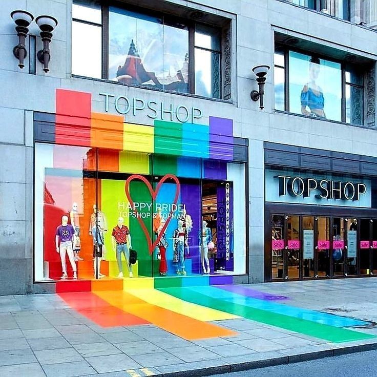 a rainbow colored store front with lots of windows