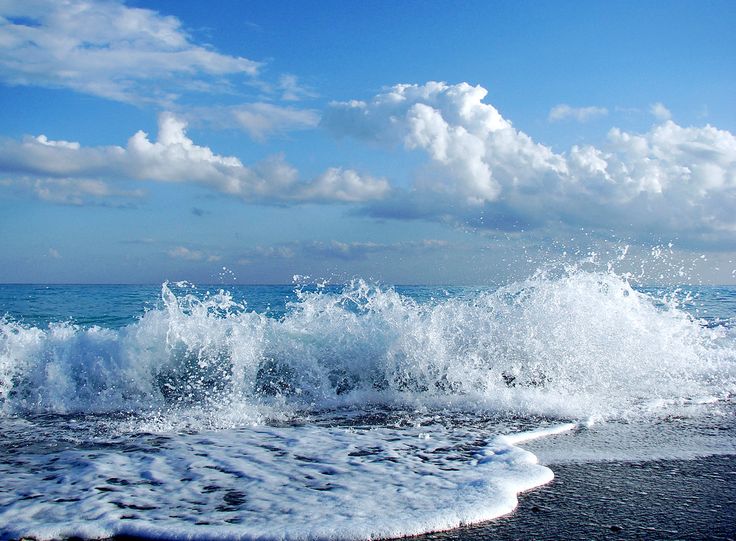 the water is splashing on the beach