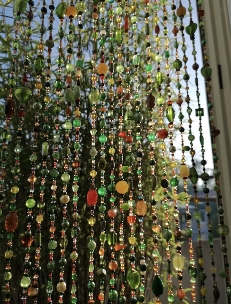 some beads hanging from the side of a window