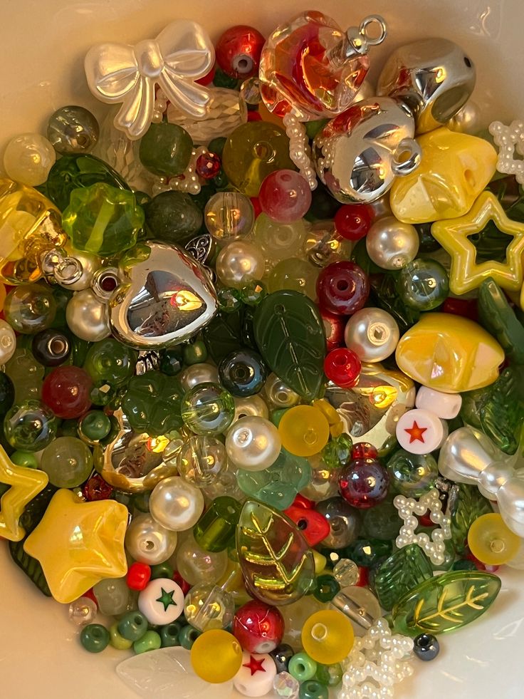 a bowl filled with lots of different colored glass beads