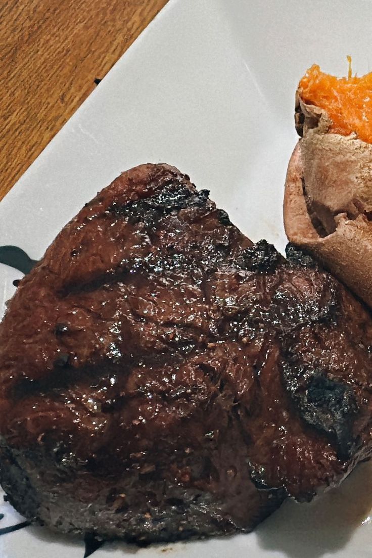 a close up of a steak sandwich on a plate