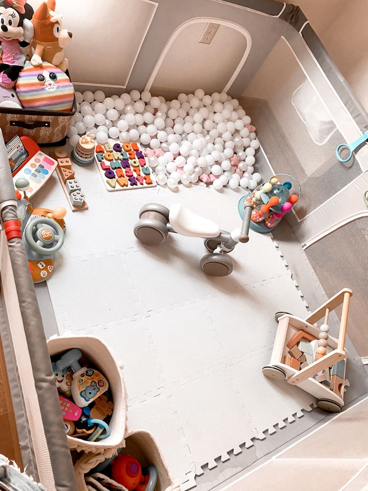 a room filled with lots of toys and stuffed animals on top of the floor next to each other