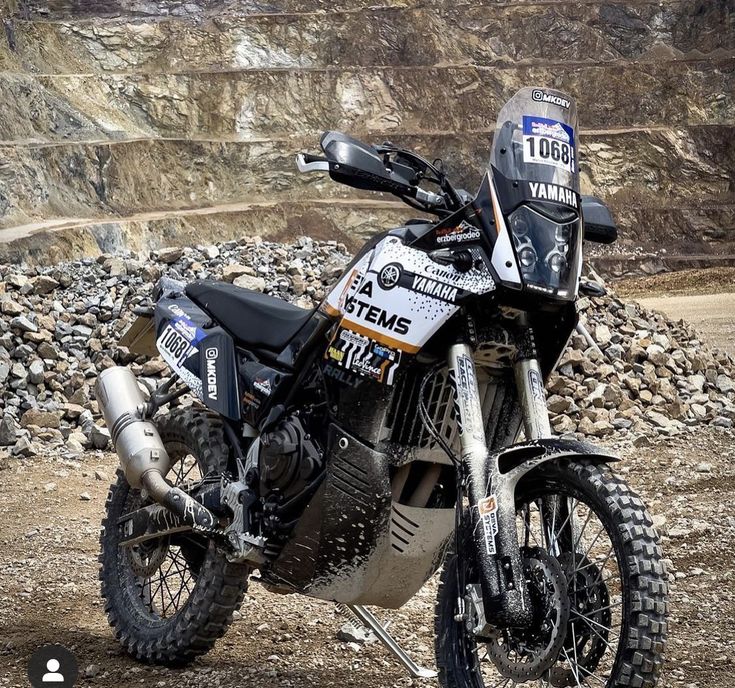 a dirt bike parked on top of a rocky hillside