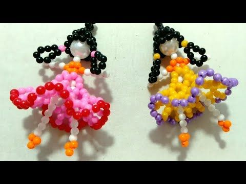 two small beaded earrings with beads on them