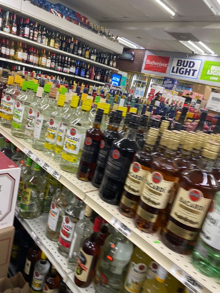 bottles of alcohol are on shelves in a liquor store