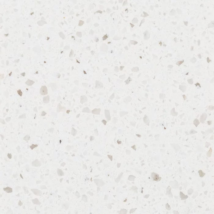 a white counter top with small speckles on it