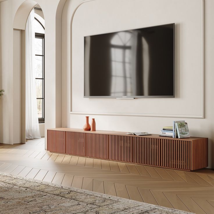 a large flat screen tv mounted to the side of a wall in a living room