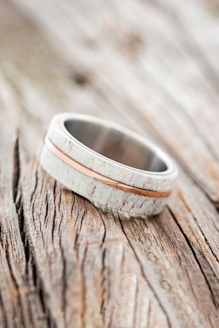 a wedding ring sitting on top of a wooden table