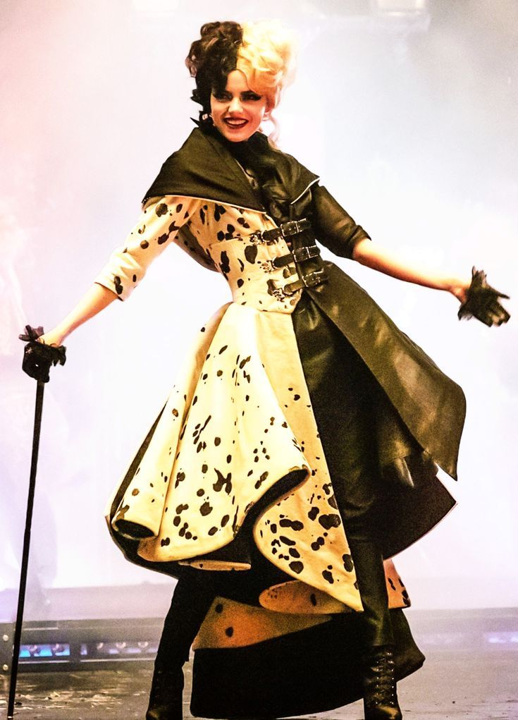 a woman dressed in black and white is posing for the camera