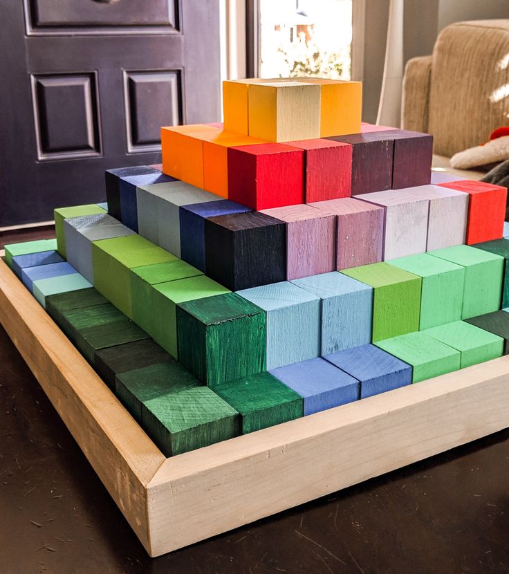 colorful blocks are stacked on top of each other in front of a door and window