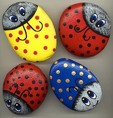 four painted rocks with ladybugs on them