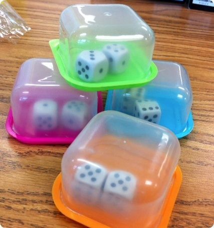 four plastic dices sitting on top of each other