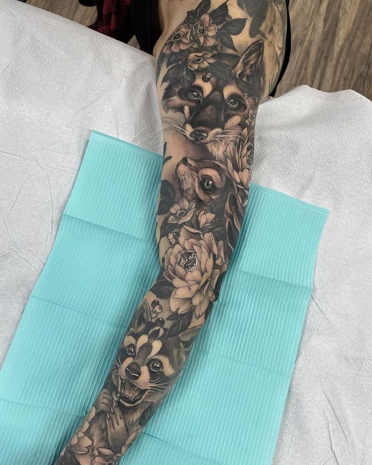 a person with a tattoo on their arm is sitting in front of a blue towel