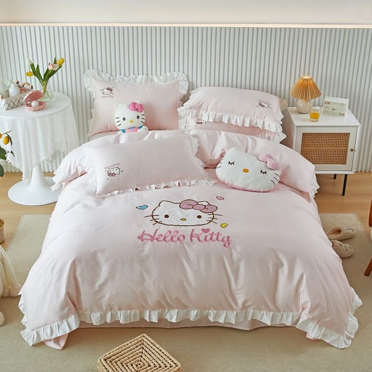 a hello kitty bed with pink comforters and pillows