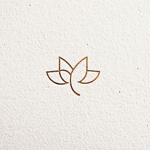 a logo for a yoga studio with two leaves on the front and back of it