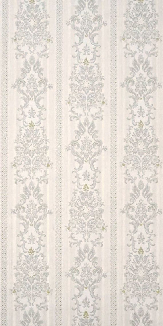 a white and blue striped wallpaper with an ornate design on the bottom half of it