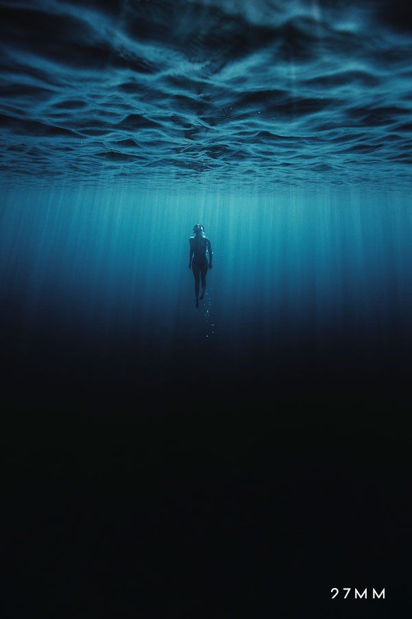 a man is swimming in the ocean under water