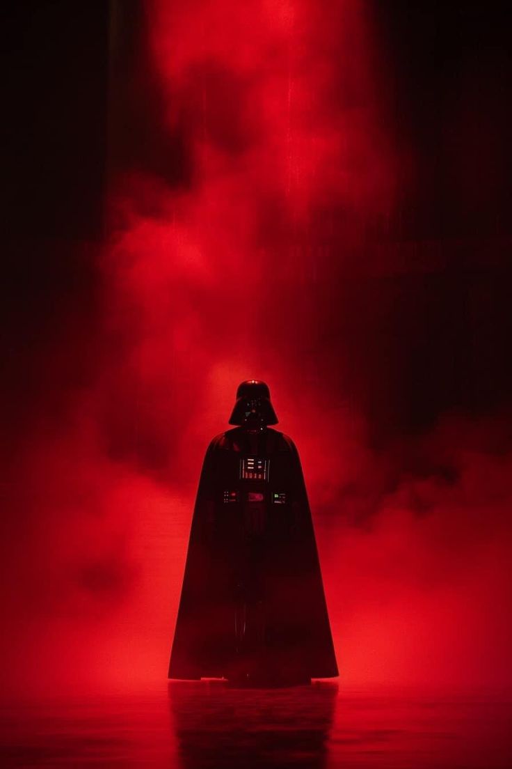 darth vader standing in the dark with red fog