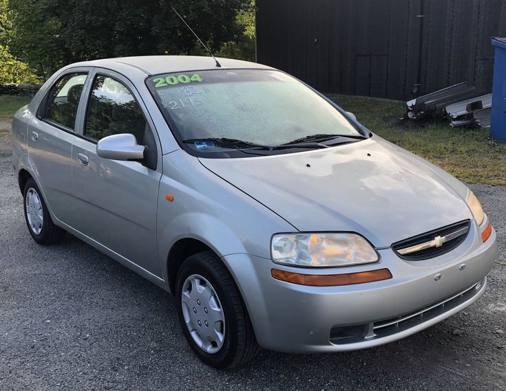 a small silver car parked in a parking lot