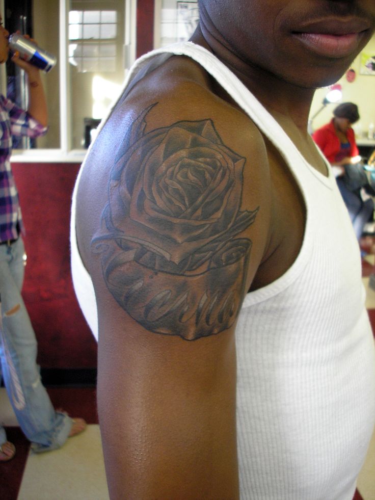 a woman with a rose tattoo on her arm and shoulder is looking at the camera