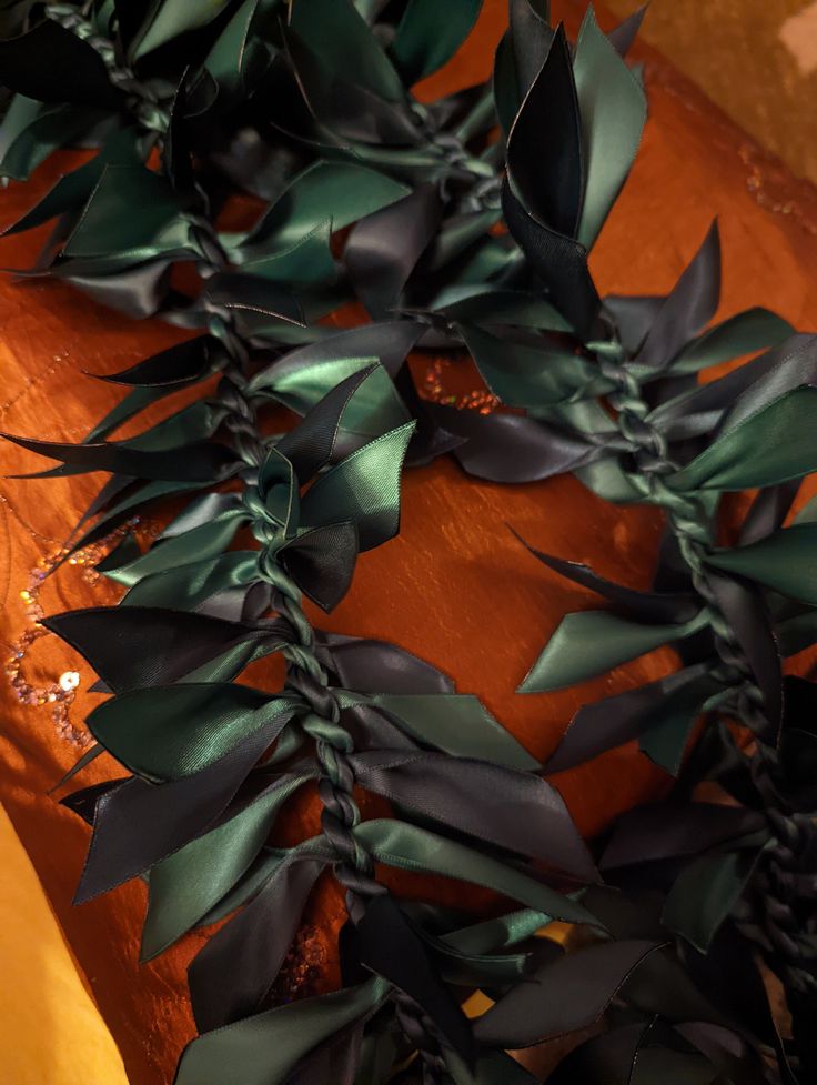 some green leaves are on a wooden table