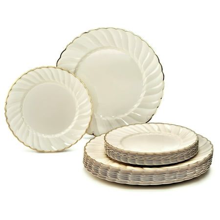 a set of four white plates with gold rims