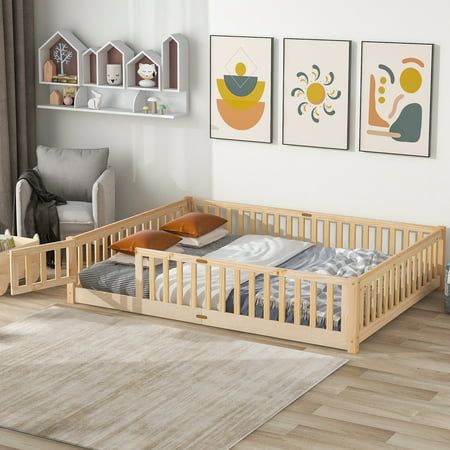 a baby crib in a living room with three pictures on the wall above it