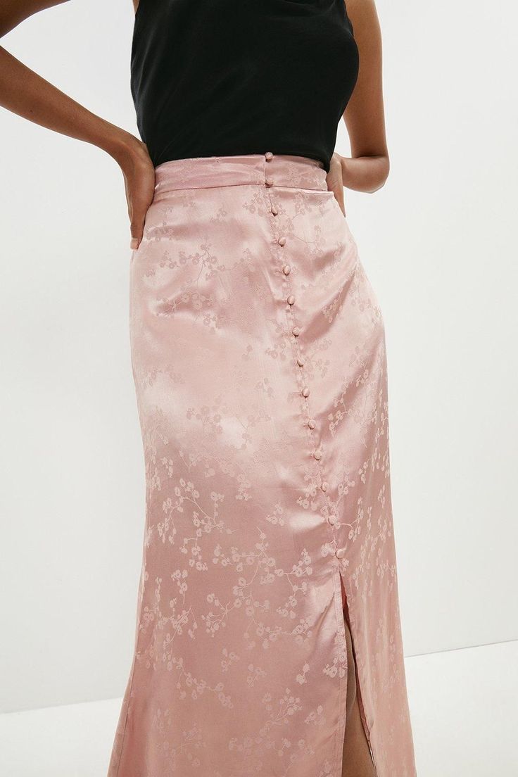 Borrowing from vintage styles, this silky satin midi skirt is at once both feminine and refined. Its tonal floral pattern and fabric-covered buttons add a romantic touch to this fluid, flirtatious design.Style: Midi SkirtFabric: SatinLength: Midi Pink Silk Skirt, Pink Satin Skirt, Skirts Satin, Satin Skirts, Latest Skirts, Satin Midi Skirt, Fabric Covered Button, Satin Skirt, Pink Skirt