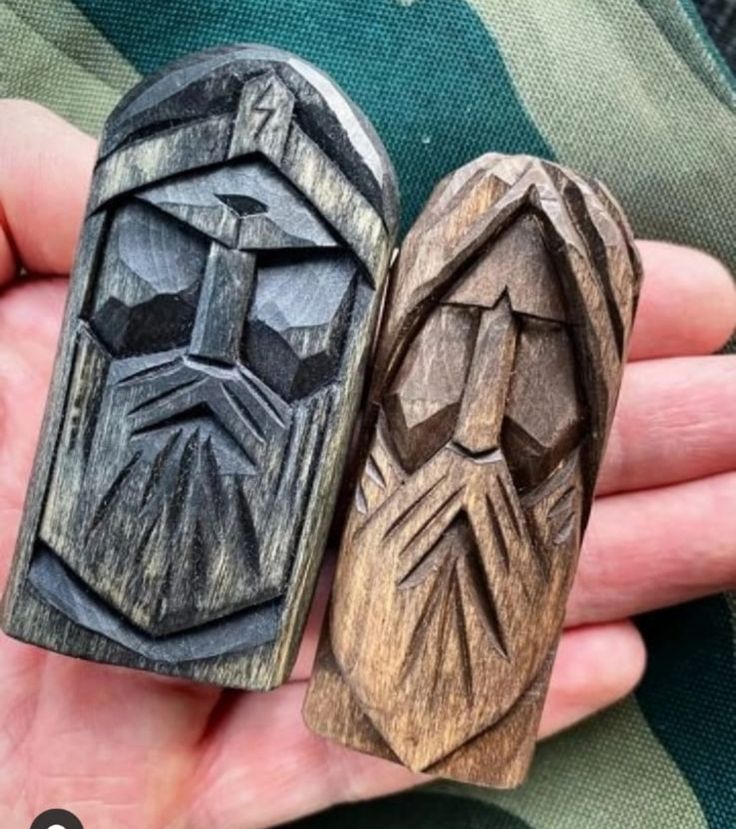 two wooden rings in the shape of darth vader's head and face