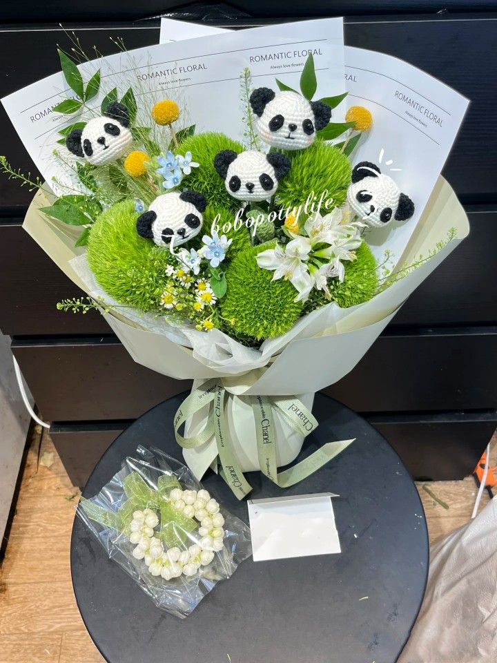 a bouquet of flowers with panda bears on it