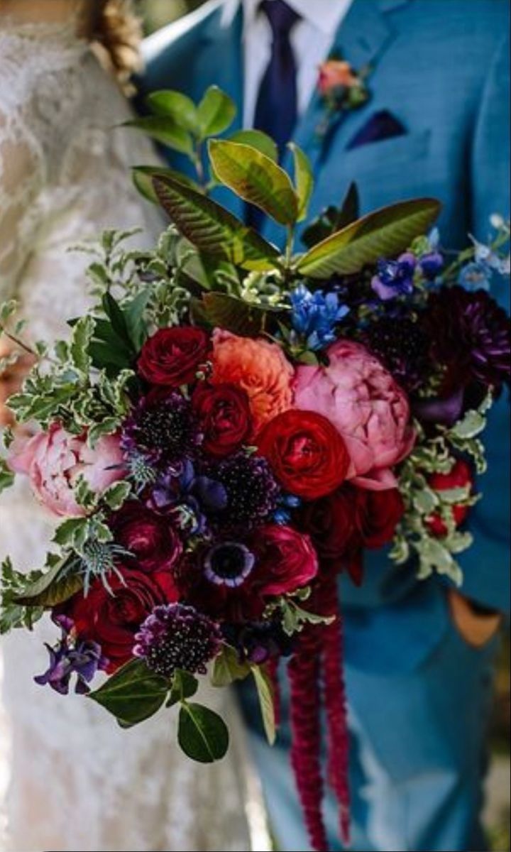 the bride and groom are holding their bouquets