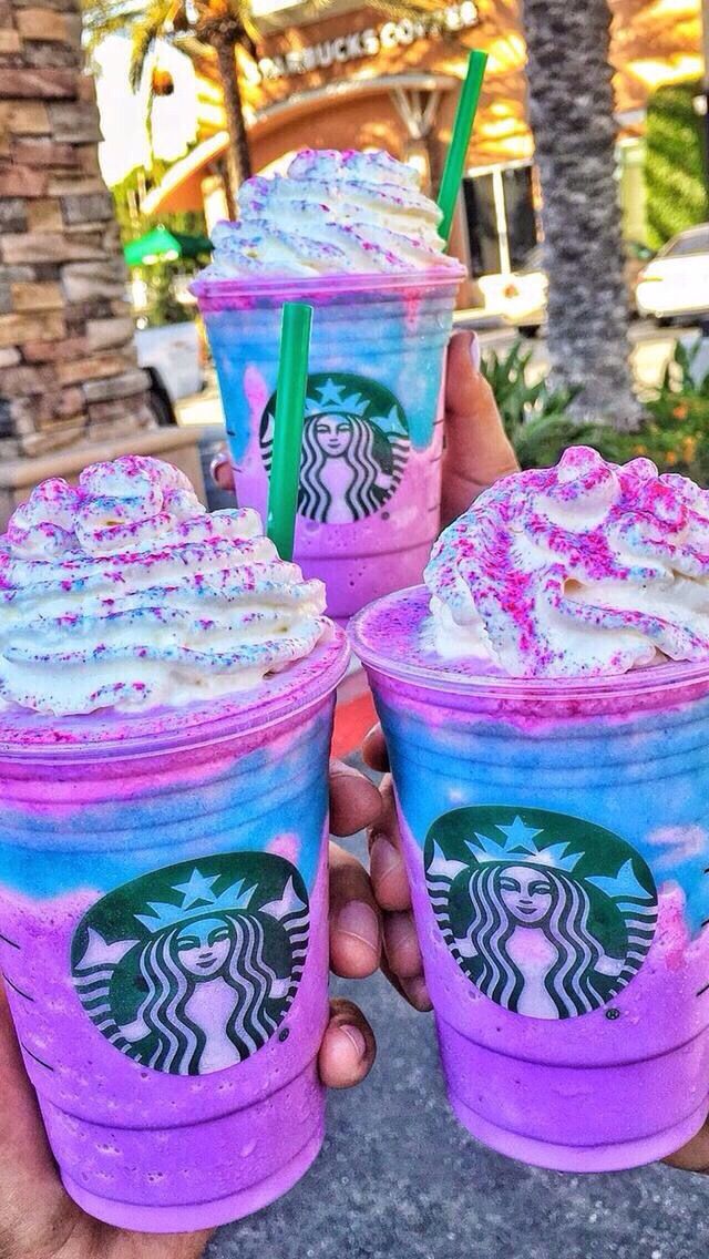 three starbucks drink cups with sprinkles and pink frosting on the top