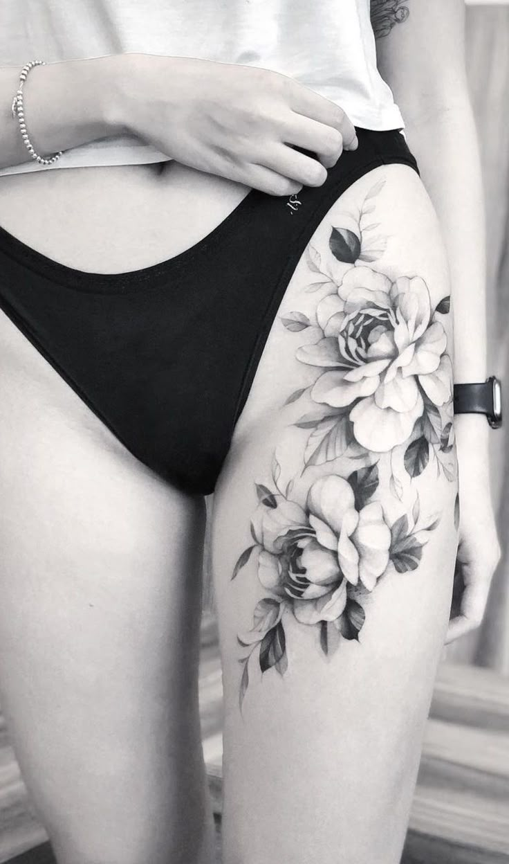 a woman's thigh with flowers on it