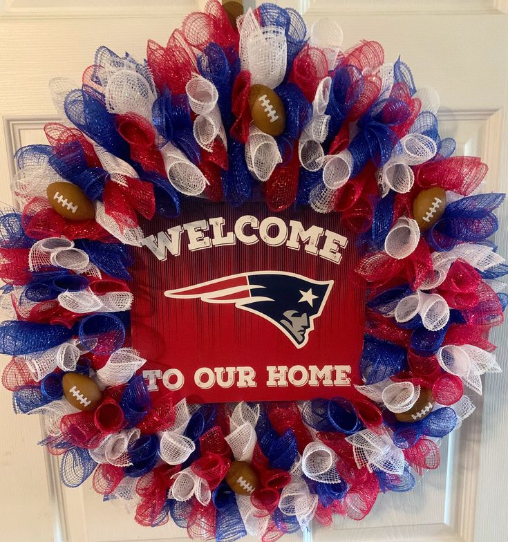 a wreath with the words welcome to our home and footballs in red, white, and blue