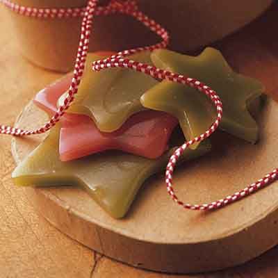 three pieces of soap sitting on top of a wooden board