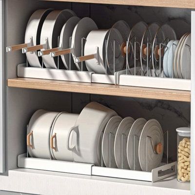 an organized dish rack with plates and cups in the kitchen cupboards for storing dishes