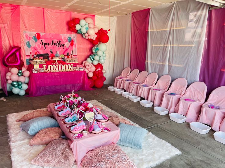 a room filled with lots of pink and white chairs covered in balloons, decorations and other items